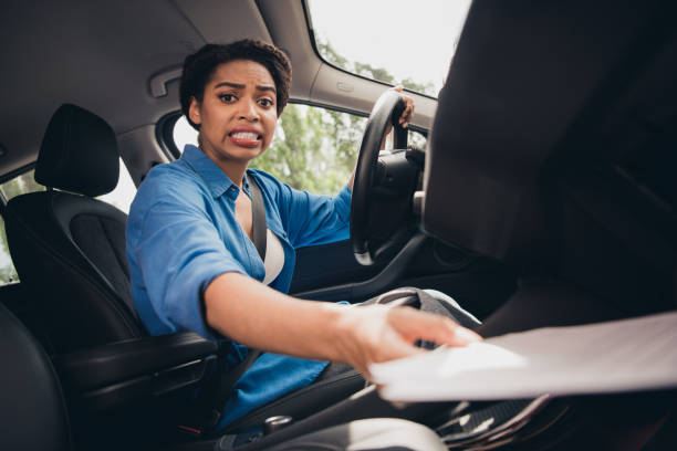 istock Young woman inside car experiencing unexpected situation while driving through urban street 2189452514