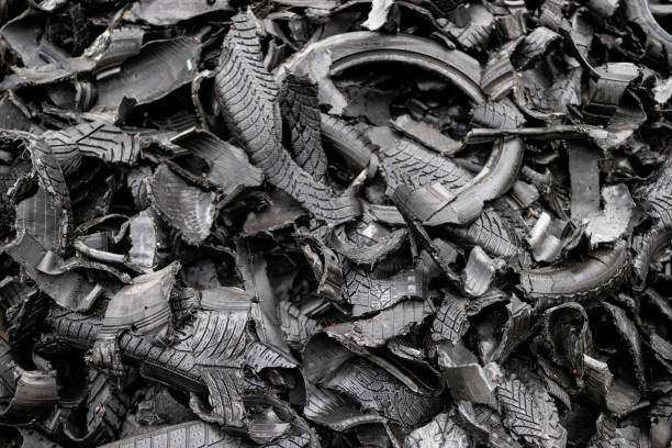 Close up of worn and scarred tires lie in heaps awaiting the  recycling