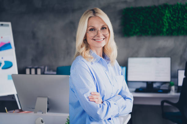 istock Confident mature businesswoman working in modern office environment with elegant style 2189455444