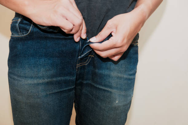 istock Close-up of man's hand Man buttoning jeans 2189455616