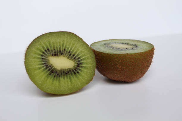 Halved kiwi fruit isolated on white background