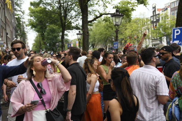 Amsterdam, Netherlands - August 3, 2024: A crowded street beside the Prinsengracht during the Pride canal parade in Amsterdam.