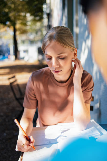 istock Teenage Student Studying Outdoors in Sunlit Park Setting 2189464284