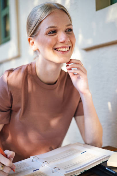 Smiling Student Studying Outdoors at a High School Campus