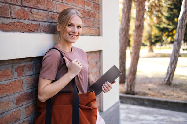 istock Smiling Student Girl Holding Tablet Outside School Building 2189464357