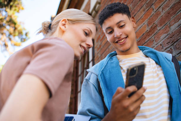 istock Two High School Students Sharing a Fun Moment with Smartphone 2189464368