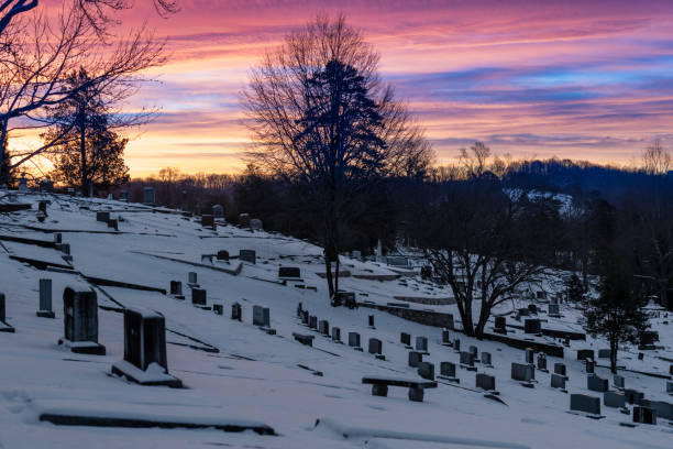 Snowy Cemetery Under Vibrant Sunset Sky