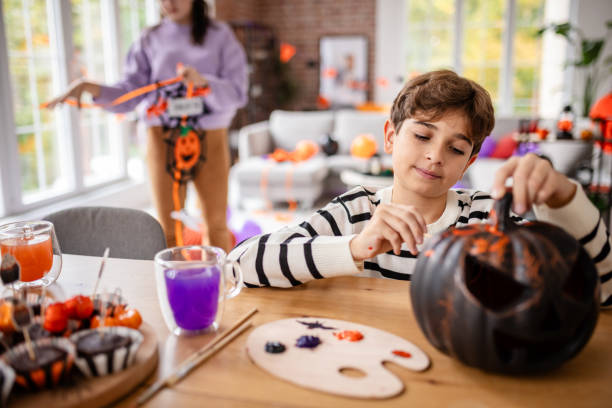 istock Kids Enjoying Pumpkin Carving for Halloween 2189468013