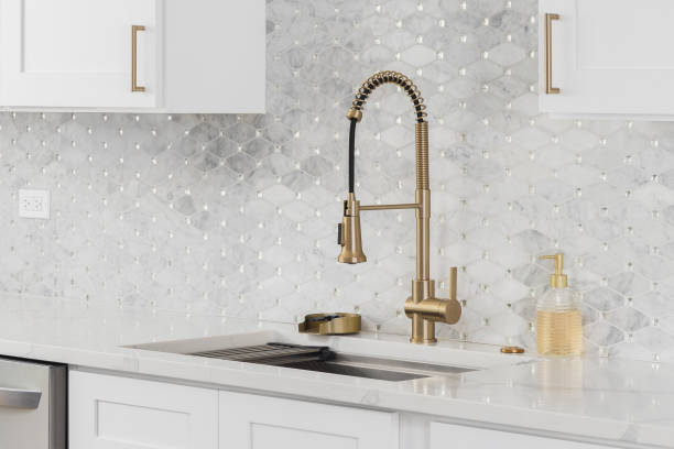 istock A kitchen with a gold faucet and tiled backsplash. 2189468875