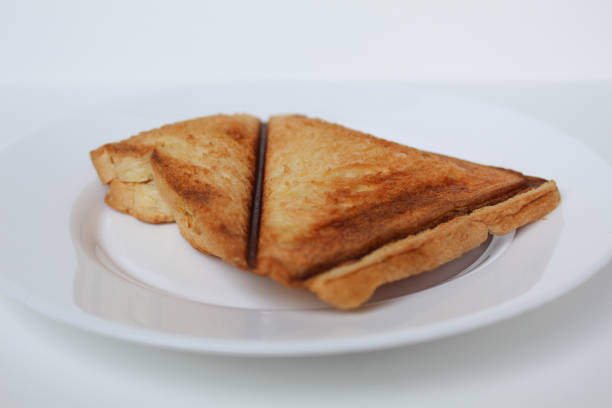 Toast or toasted bread, on white plate, isolated on white background