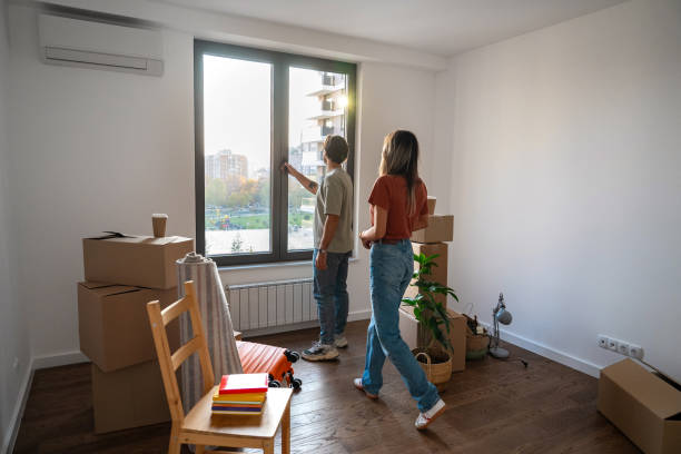 istock Couple opening window in their new apartment 2189471504