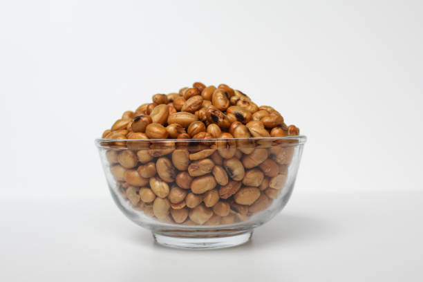 Fried soy bean on transparent glass bowl, isolated on white background