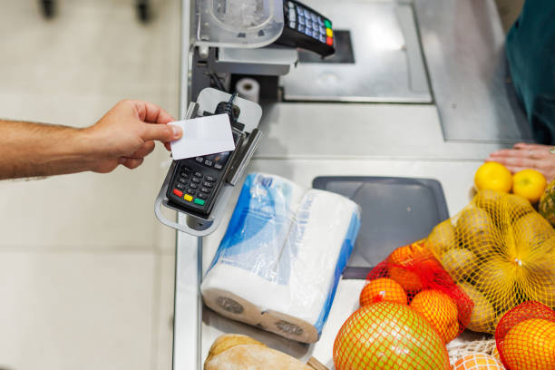 istock Customer paying with contactless credit card at supermarket checkout 2189472015