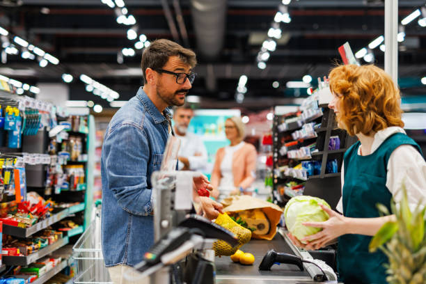 istock Customer paying for groceries at supermarket checkout counter 2189472019