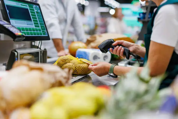 Cashier scanning barcode at checkout