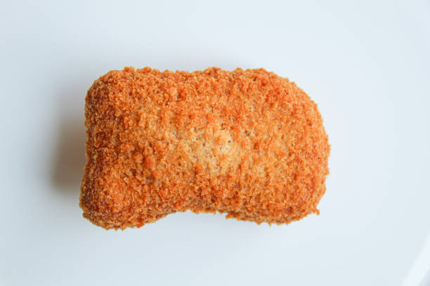 One fried chicken nugget on white plate, isolated on white background