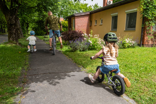 istock Family Enjoying Bicycle Outing in Suburban Area 2189473129