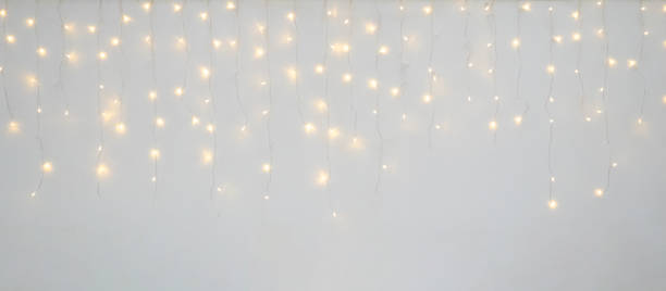 istock Christmas light decoration blurred festive gold bokeh light on white background 2189473394
