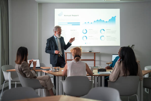 istock Mixed Race People In Meeting Room With Wall Projection 2189474790