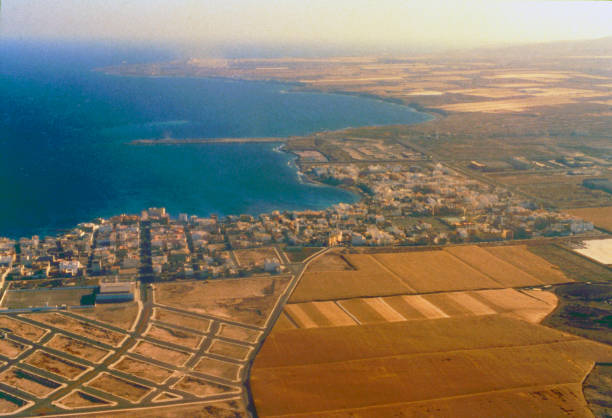 Deep blue sea and coastal homes seen from the plane