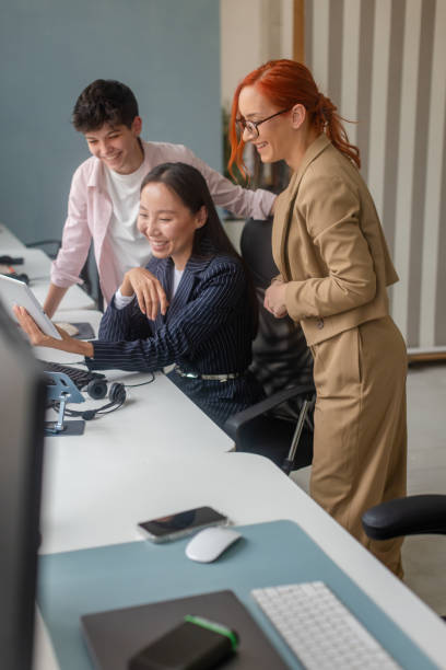 istock Group of professionals collaborating at desk in modern office environment 2189476508