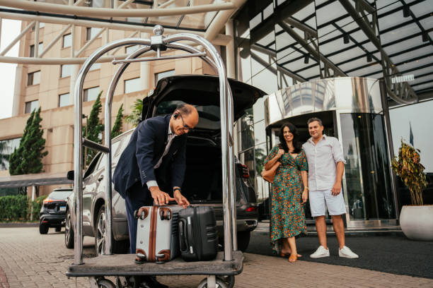 istock Hotel attendant carrying guests' bags 2189476915