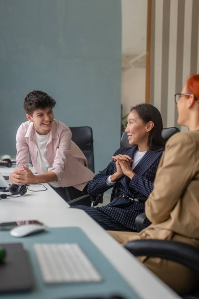 istock Group of colleagues having a discussion in an office setting 2189477204