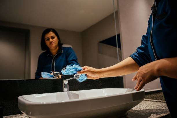 Maid tidying hotel room