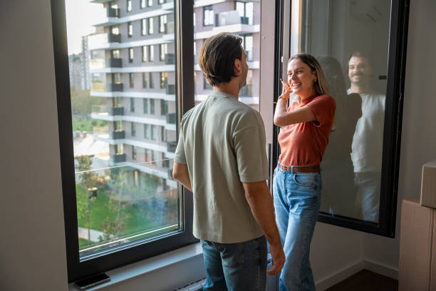 istock Couple in love smiling by the window 2189485025