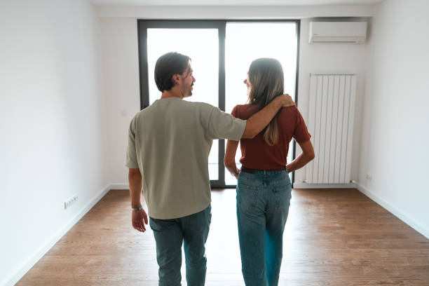 istock Rear view of embracing couple in empty place 2189485352