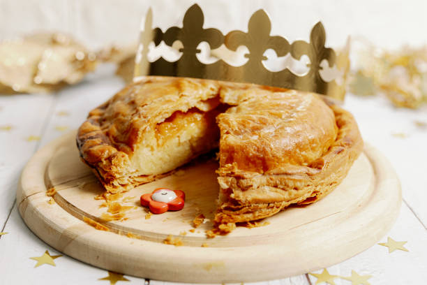 istock One cut royal galette with a crown and a surprise gift on the table. 2189486587
