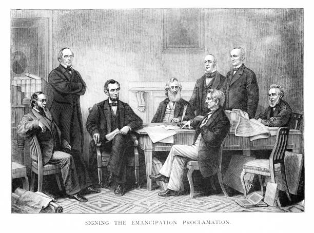 President Abraham Lincoln writes the Emancipation Proclamation, issued September 22, 1862, freeing all slaves as of January 1, 1963, during the American Civil War. Secretary of State William Seward and others in Lincoln's administration signed the document. Illustration published 1882.