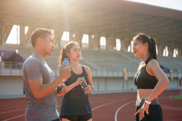 istock A group of athlete runners resting on a running track after training at a stadium on a sunny day. 2189491913