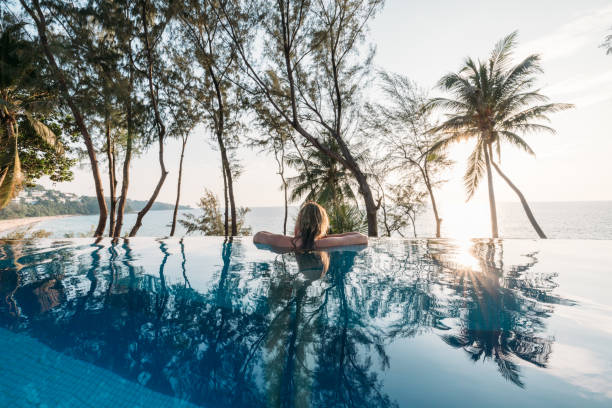 istock Woman Relaxing in Infinity Pool with Ocean View 2189494701