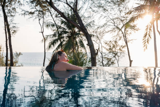 istock Woman Relaxing in Infinity Pool with Ocean View 2189494789