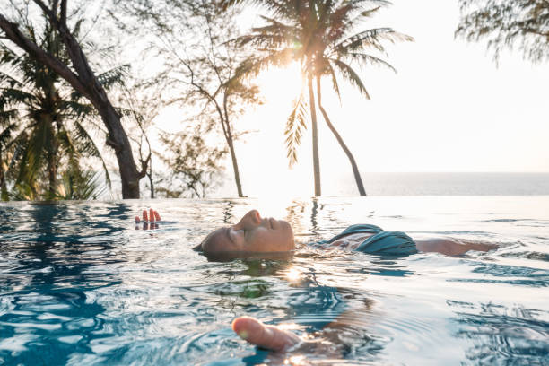 istock Person Relaxing in Infinity Pool at Tropical Resort 2189494954