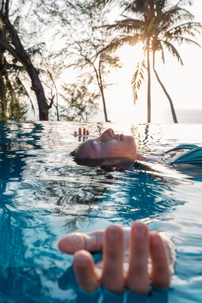 istock Person Relaxing in Infinity Pool at Tropical Resort 2189495014