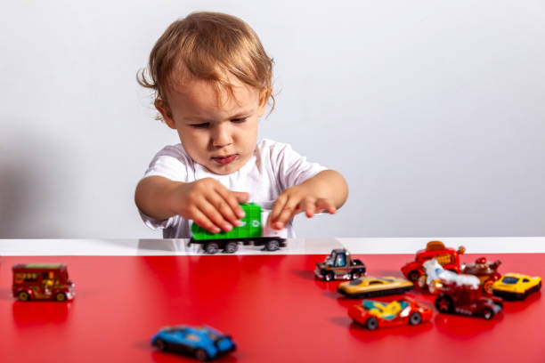 istock Child playing with toy cars on track 2189497419