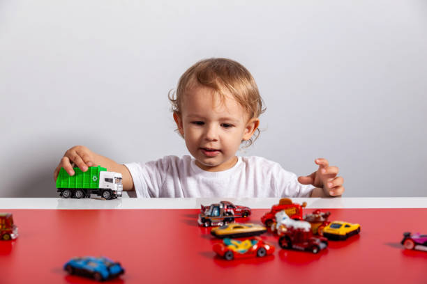 istock Child playing with toy cars on track 2189497437