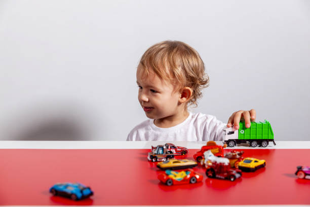 istock Child playing with toy cars on track 2189497444