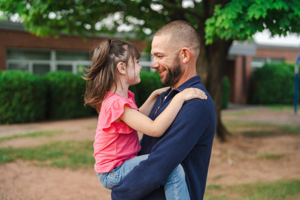 istock Father holding her daughter at the park and looking each other 2189497696
