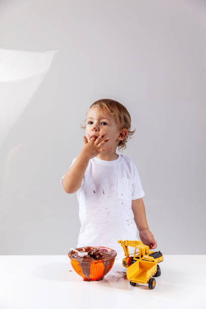 Child eating ice cream with backhoe toy