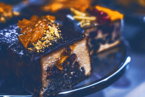 istock Fresh chocolate cake with golden cream on top on display at a large store. 6K 2189502603
