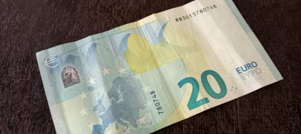 istock Euro bank note on wood background 2189506933