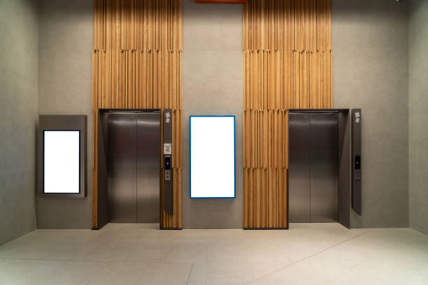 istock Metal Elevator Lobby with two vertical Mockup Billboard in modern building 2189509566