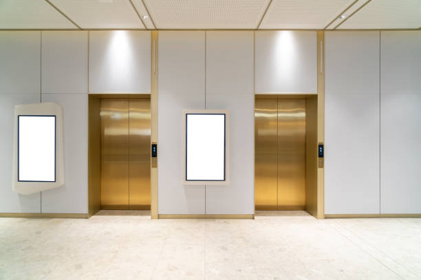 istock Metal Elevator Lobby with two vertical Mockup Billboard in modern building 2189509871
