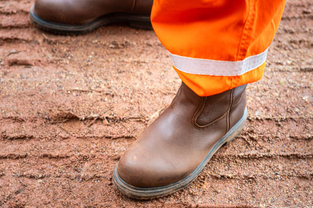 istock A construction worker is wearing safety shoe, standing on dirt ground. 2189510099