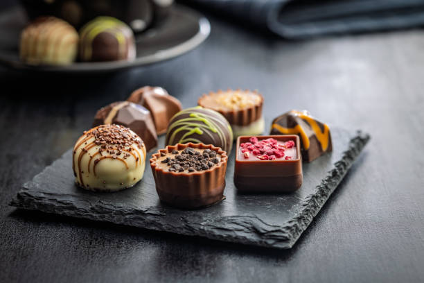 istock Mix of chocolate pralines on black table. 2189512393