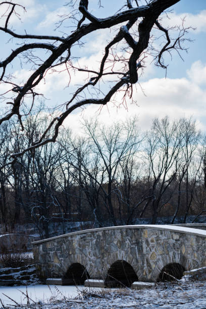 Old stone bridge and bare trees at Silver Lake Park, Rochester, Minnesota