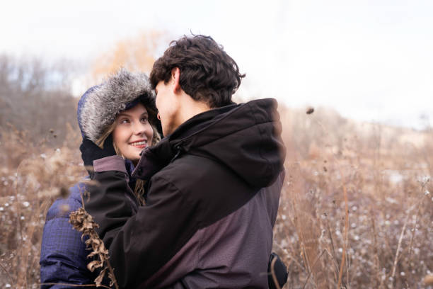 two 15-year-old teenagers in love play, hug and spend time together in an autumn park